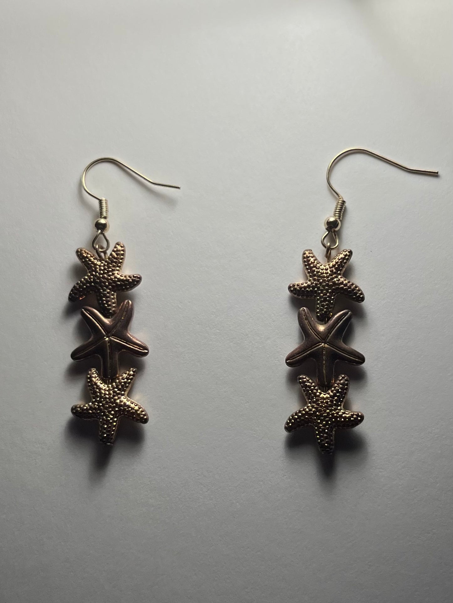 Gold star fish earrings