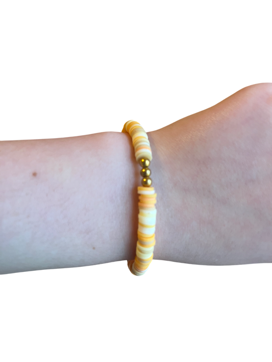 Orange clay bead bracelet with gold beads