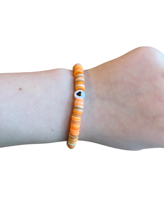 Orange clay bead bracelet with black heart